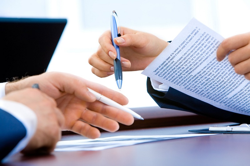 Hands filling out paperwork.