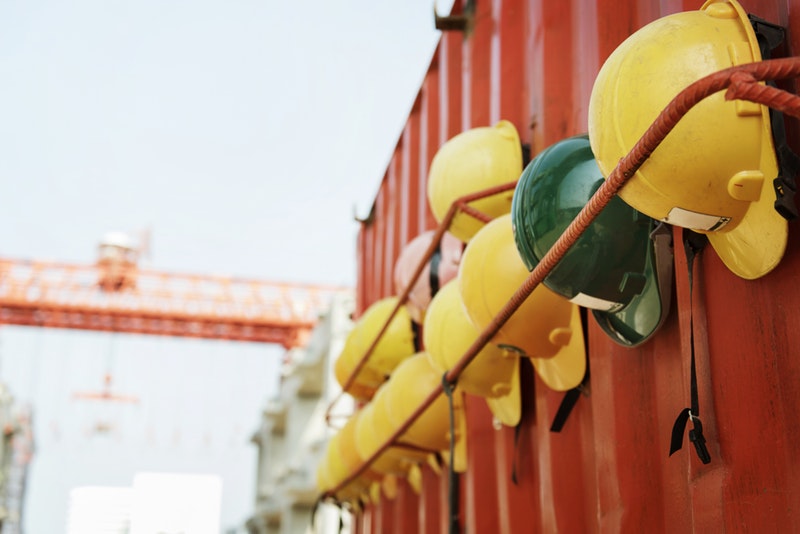 Several construction hats hung up at a construction site.